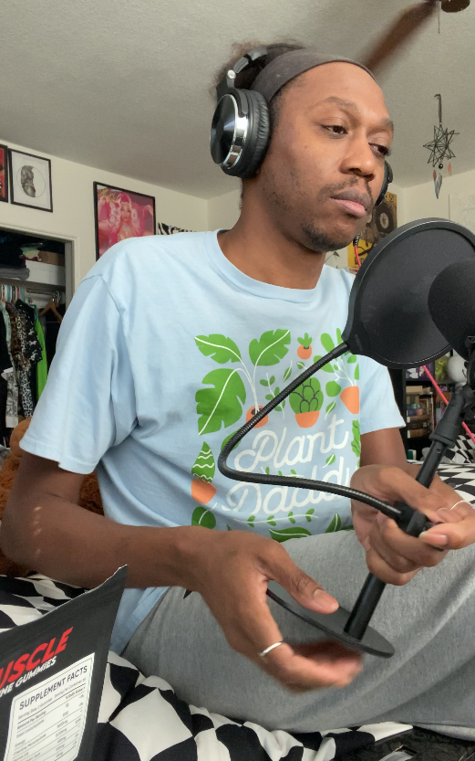 A man recording audio with a microphone and headphones.