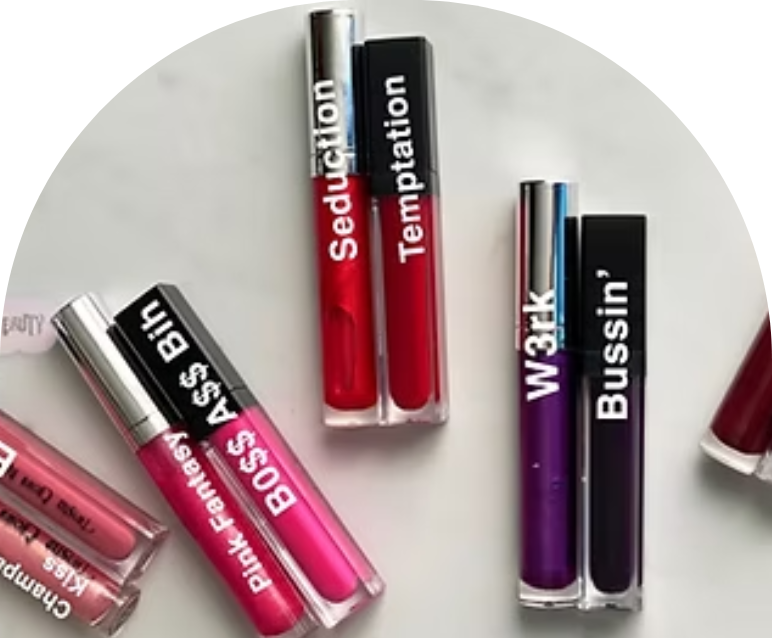 Various shades of lip gloss tubes arranged on a white surface.