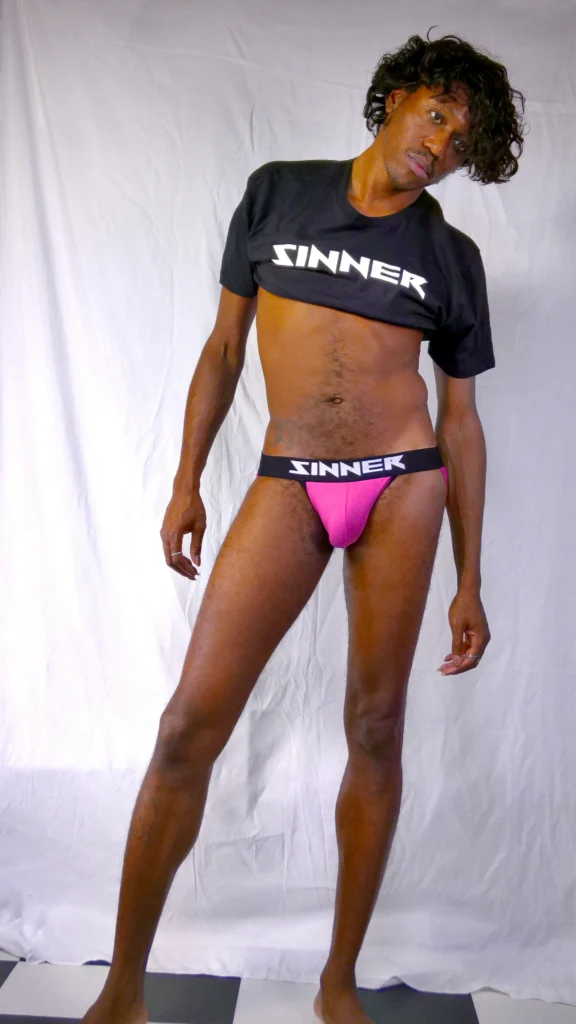 Naomi Wynters (Dammon T. Johnson) wearing sinner logo Tee + Dual Candy Jockstrap