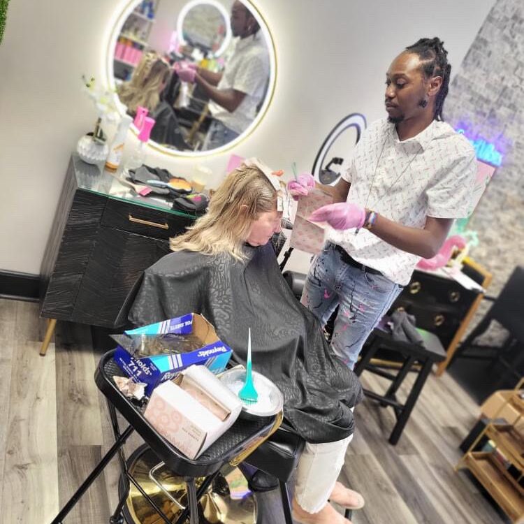 Hairdresser styling a client's hair in a modern salon.